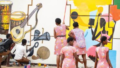 enior high school Visual Arts students creating murals at the Asokwa Interchange during Ashanti Street Art Festival 2026.