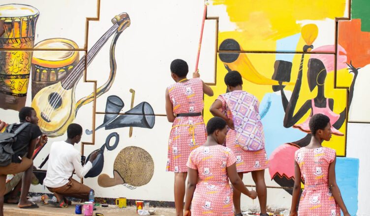 enior high school Visual Arts students creating murals at the Asokwa Interchange during Ashanti Street Art Festival 2026.